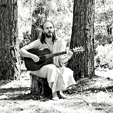 Swami Kriyananda plays guitar and sings, early 1970s.